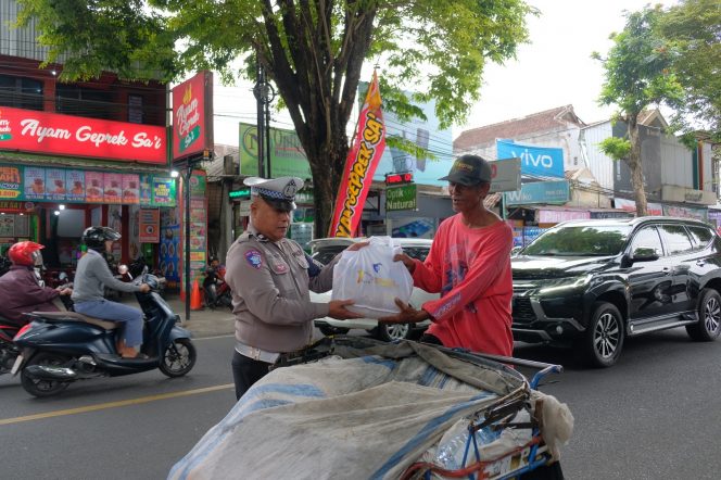 
 Personel Satlantas Polres Malang membagikan sembako di Kecamatan Kepanjen, Senin (15/9/2025).(Humas Polres Malang).