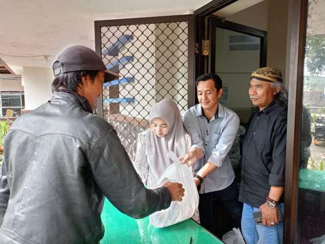 
 Kades Tulungrejo, Suliono saat tengah membagikan paket Sembako kepada warganya. (Yan)