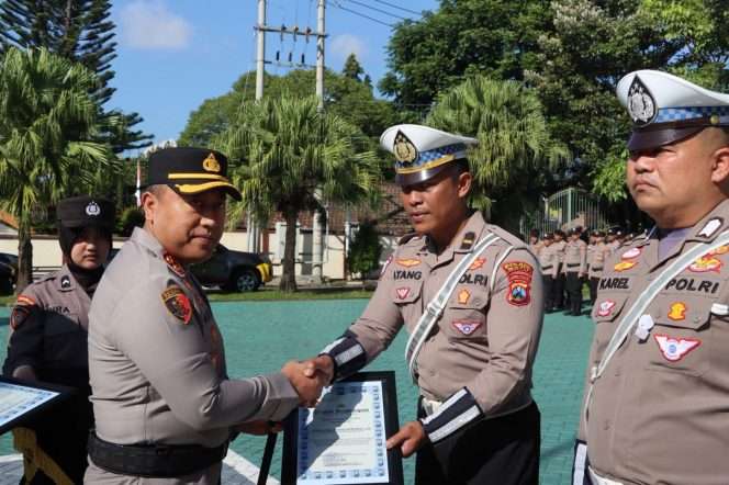 
 Kapolres Batu AKBP Dr. Aris Purwanto, S.H., S.I.K., M.H. saat memberikan reward kepada sejumlah personel Polres Batu yang berprestasi dalam pelaksanaan tugas, pada kegiatan apel yang digelar di halaman Mapolres Batu. (Yan)