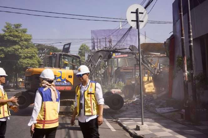 
 DPUPR Kota Batu, saat tengah melakukan pembongkaran pos polisi yang merupakan lahan aset milik Pemkot Batu. (Yan)